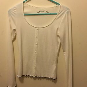 A white, fitting long sleeve shirt